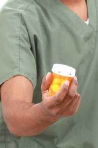 Nurse with medicine bottle in hand