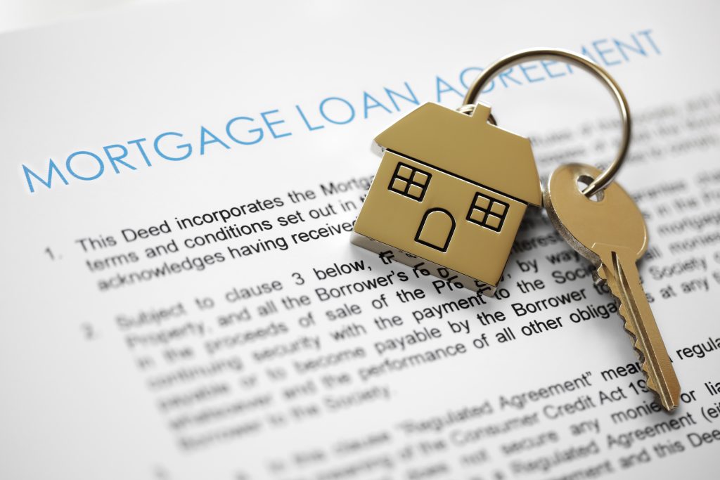 Mortgage loan agreement application with house shaped keyring