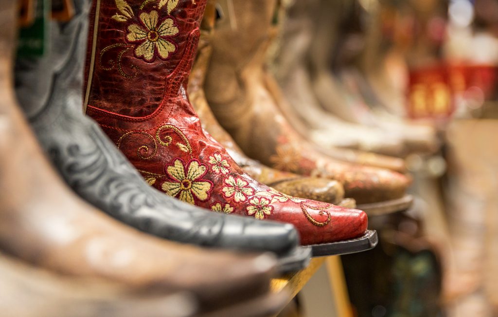 Cowboy boots being displayed on a shelf