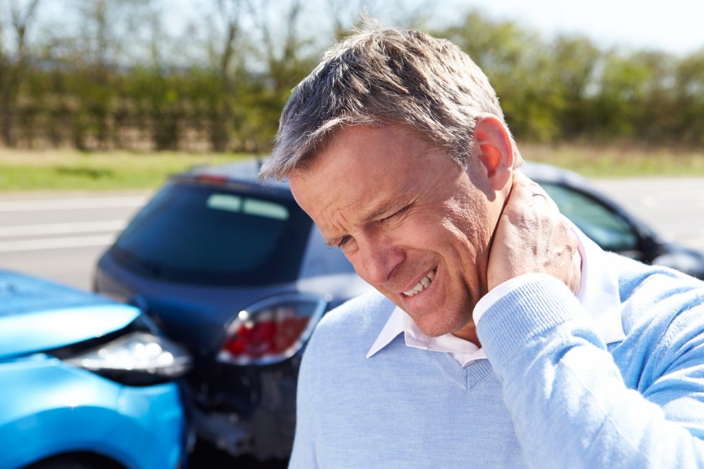 A man experiencing a whiplash injury