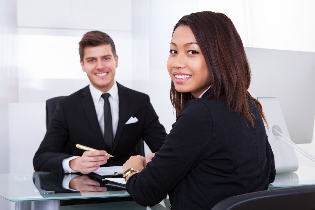 an applicant with a recruiter smiling