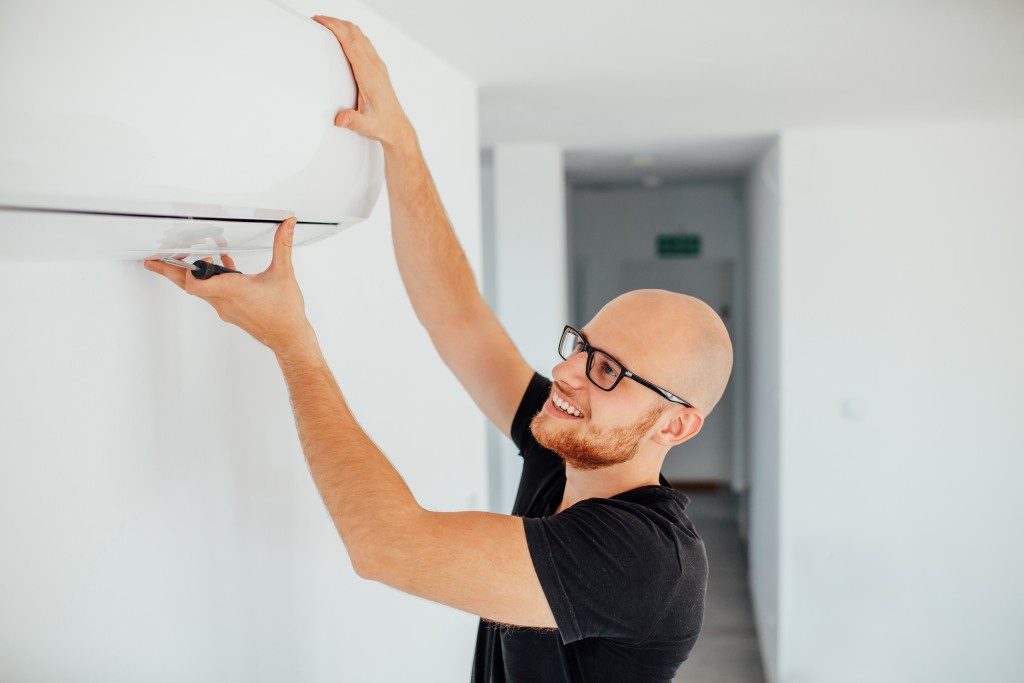 Man fixing the air conditioner