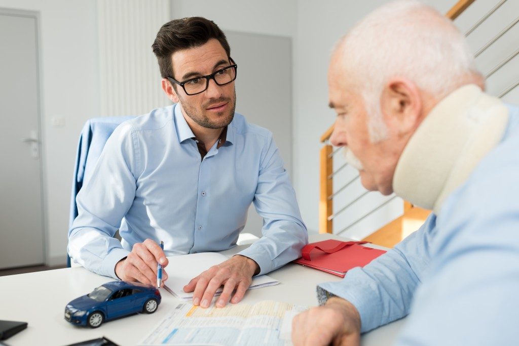 Injured man consulting with lawyer