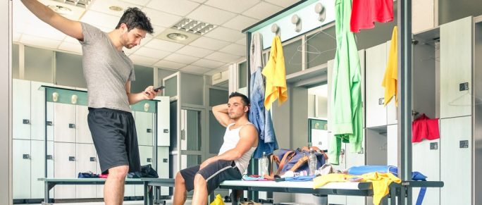 Two men at gym locker room