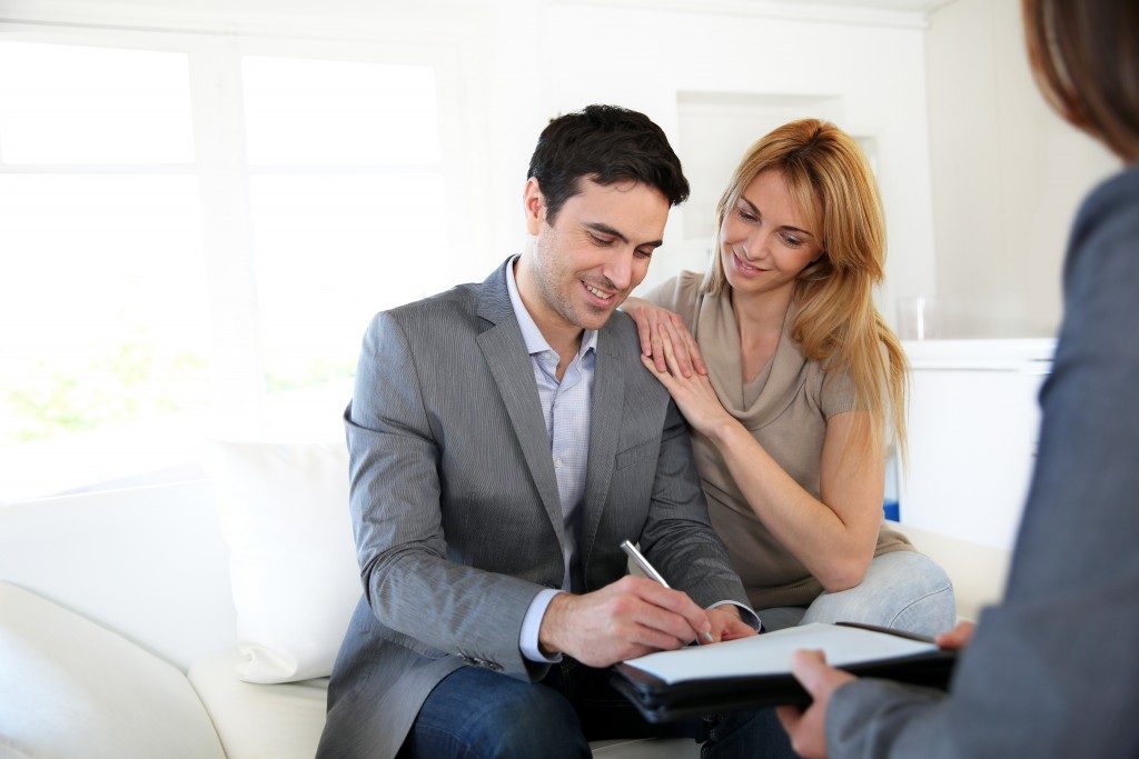 A couple signing a document from a real estate lawyer