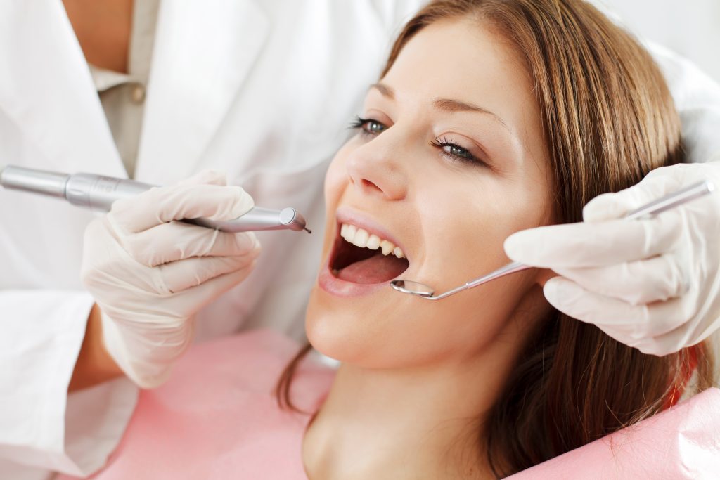 a young woman getting a dental treatment