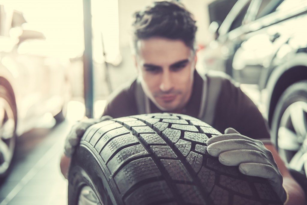 a man examining a tire