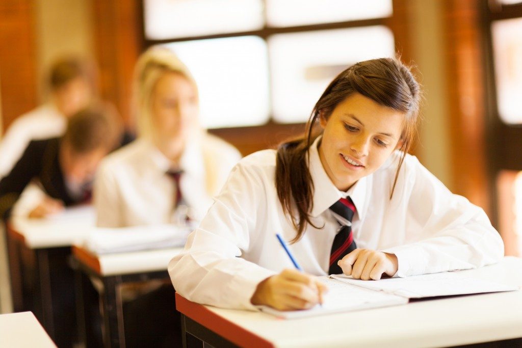 Student in class taking down notes