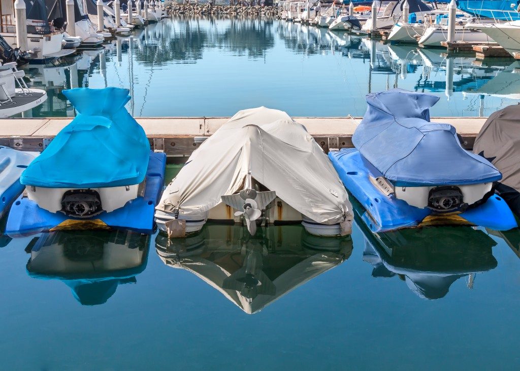 covered boats by the shore