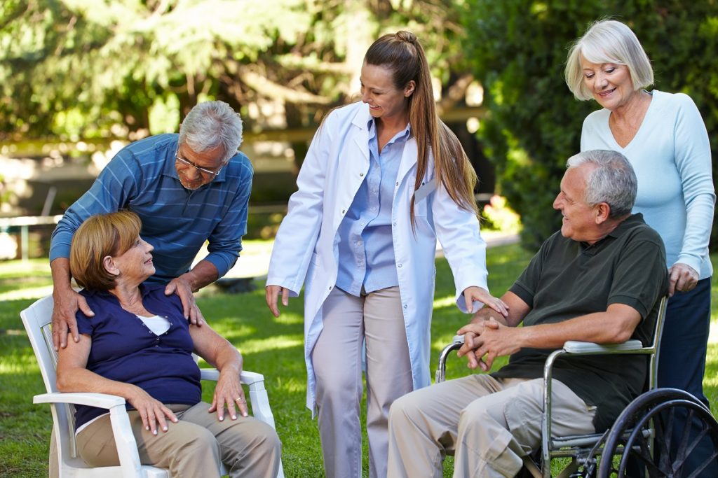 Seniors and nurse relaxing outdoors