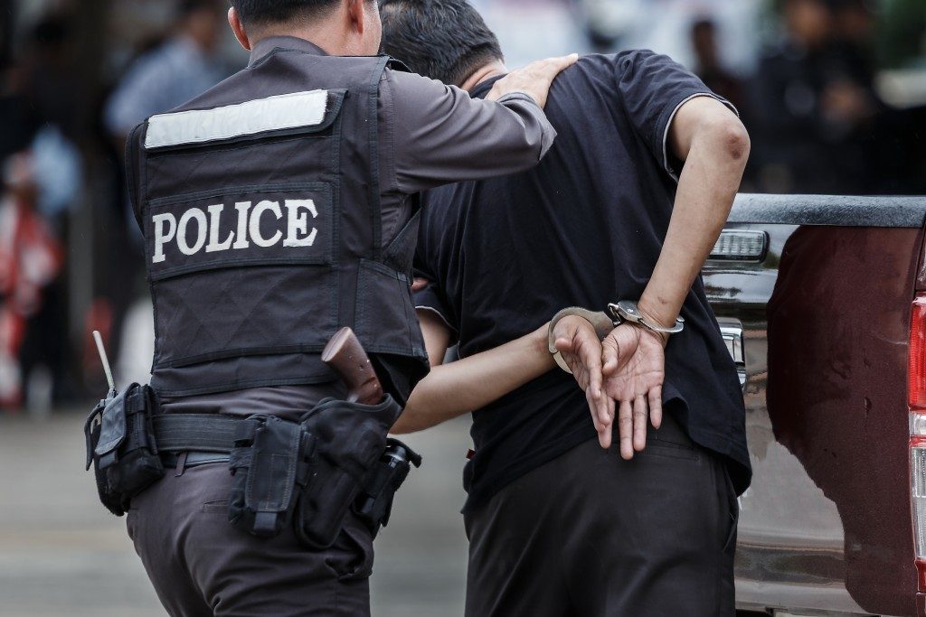 policeman with a handcuffed person