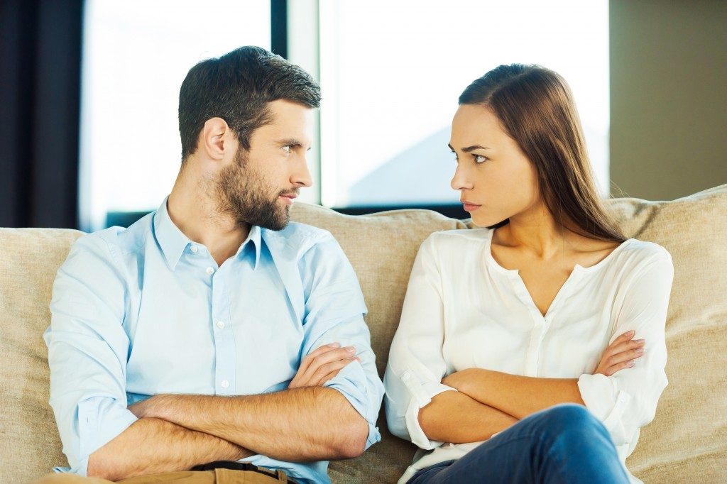 Couple looking at each other angrily