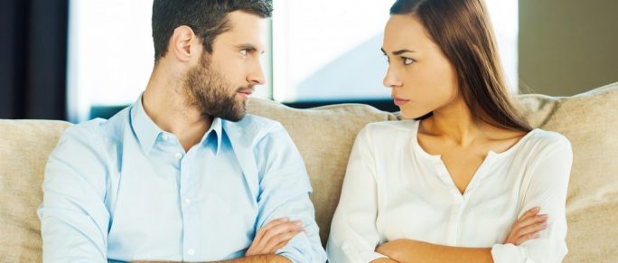 Couple looking at each other angrily