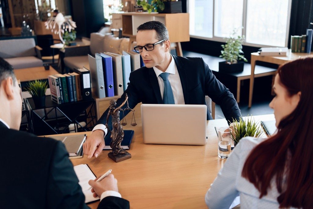 Lawyer instructing divorcees where to sign