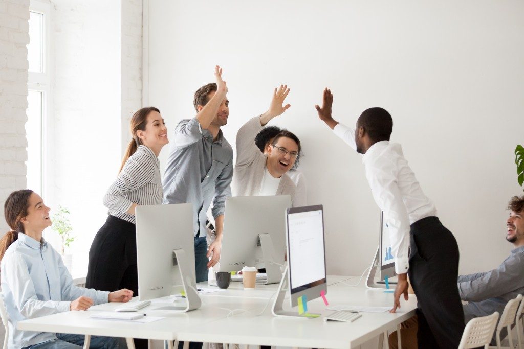 Happy employees giving each other high fives