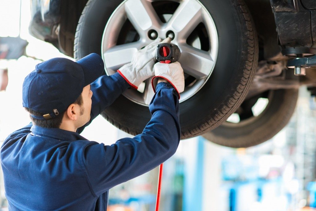 man fixing tires at an auto repair shop