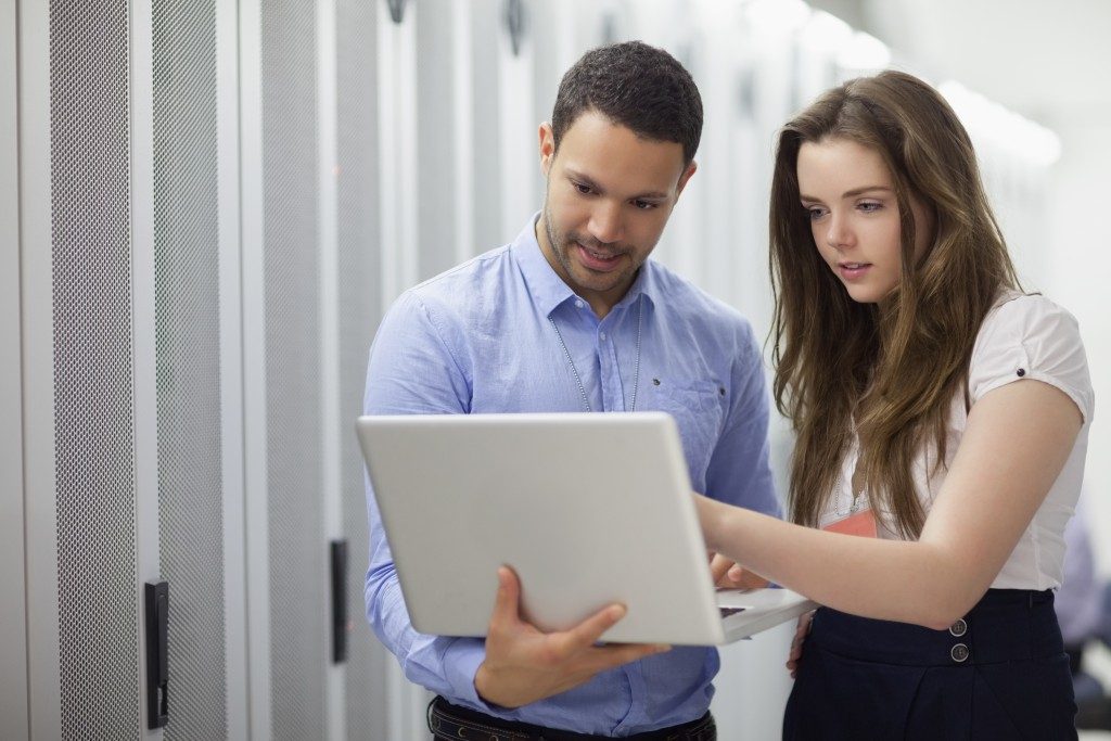 Man and woman using the laptop